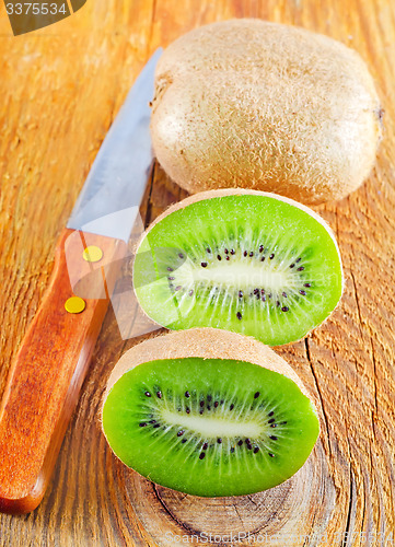 Image of fresh kiwi on the wooden board