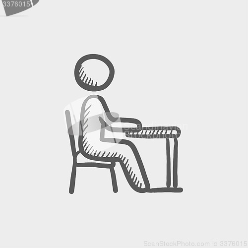 Image of Student sitting on a chair in front of his table sketch icon