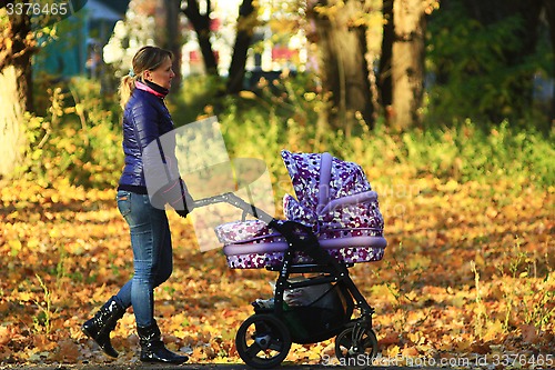 Image of woman with perambulator in the park