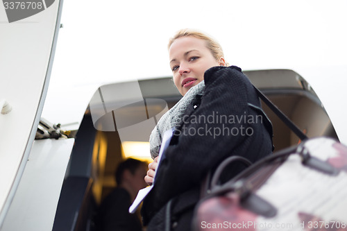 Image of Woman boarding airplain.