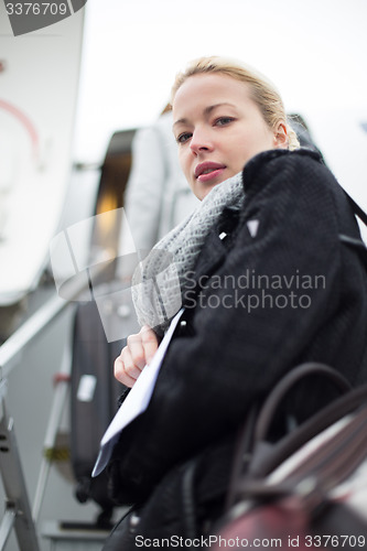 Image of Woman boarding airplain.