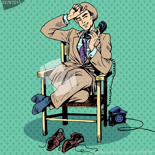 Image of Tired man sits chair talking phone