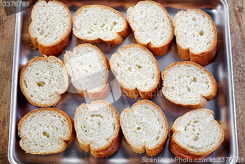 Image of bread slices on oven pan