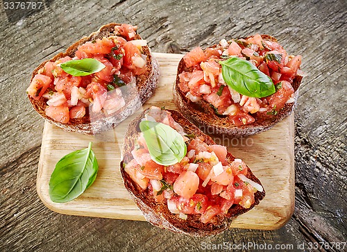 Image of toasted bread with chopped tomatoes