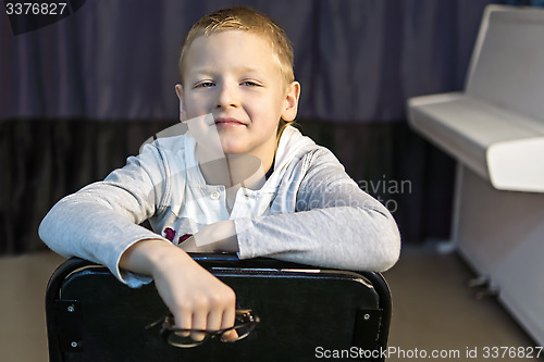 Image of Boy near white piano