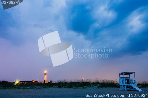 Image of tybee island beach lighthouse with thunder and lightning