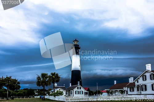 Image of tybee island beach lighthouse with thunder and lightning