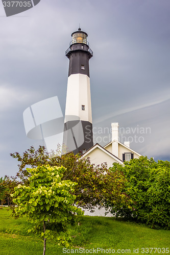 Image of tybee island beach lighthouse with thunder and lightning