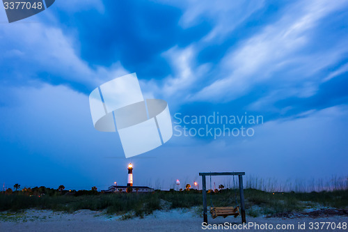 Image of tybee island beach lighthouse with thunder and lightning