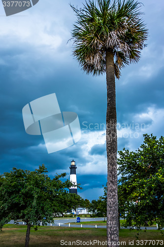 Image of tybee island beach lighthouse with thunder and lightning