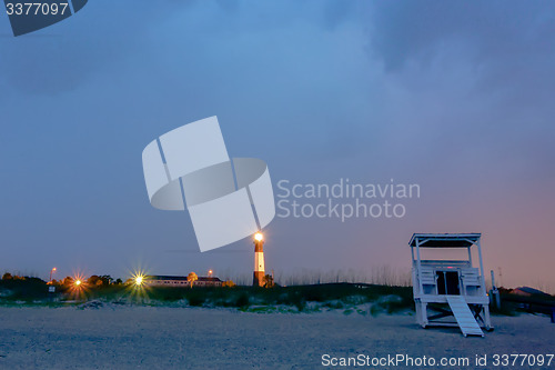 Image of tybee island beach lighthouse with thunder and lightning