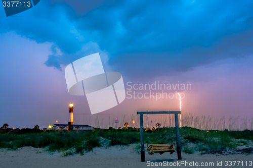 Image of tybee island beach lighthouse with thunder and lightning