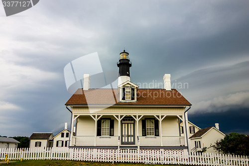 Image of tybee island beach lighthouse with thunder and lightning