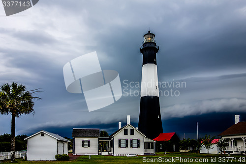 Image of tybee island beach lighthouse with thunder and lightning