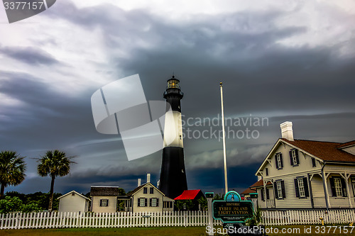 Image of tybee island beach lighthouse with thunder and lightning