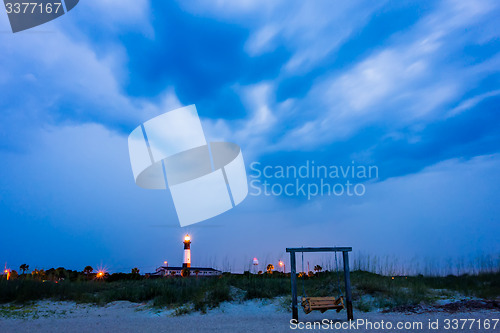 Image of tybee island beach lighthouse with thunder and lightning