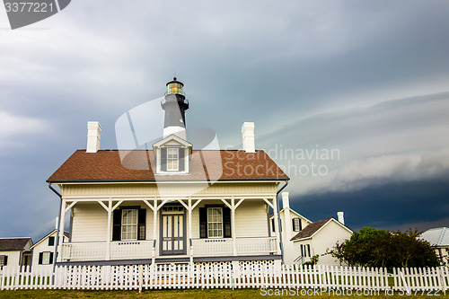 Image of tybee island beach lighthouse with thunder and lightning