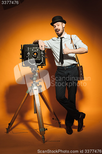 Image of young man with retro camera 