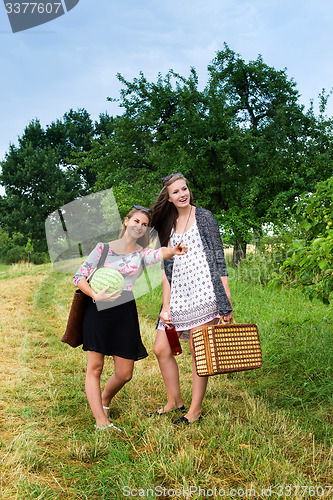 Image of Two girls getting ready for a picnic