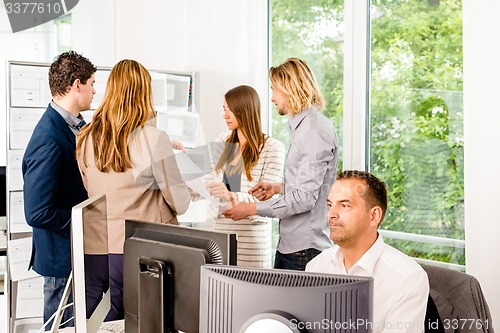 Image of Businesspeople working in office