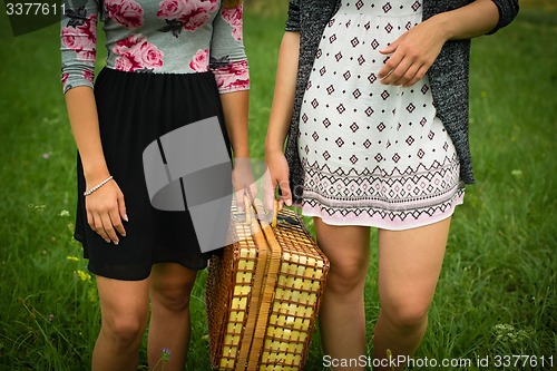 Image of Two girls getting ready for a picnic