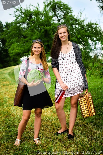 Image of Two girls getting ready for a picnic