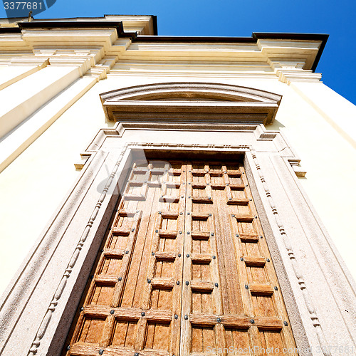 Image of  entrance   door    in italy   ancian wood and traditional  text