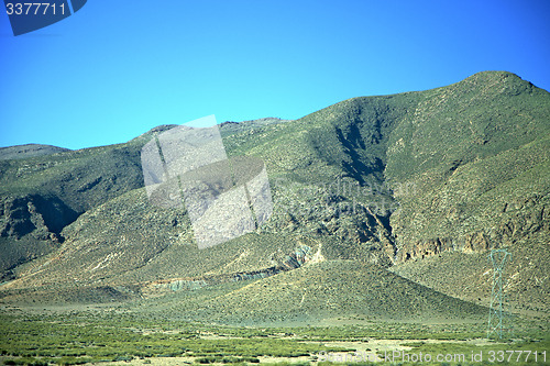 Image of valley in  electrical line high voltage power isolated hill 