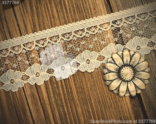 Image of vintage button and lace tape