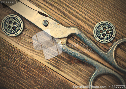 Image of vintage buttons and a dressmaker scissors