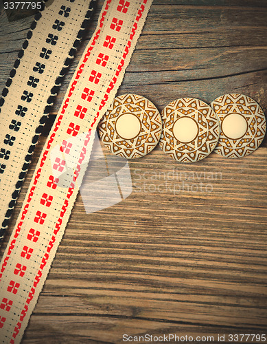 Image of vintage buttons and antique band with embroidered ornaments