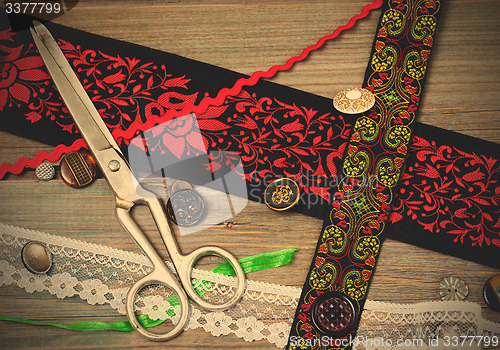 Image of vintage scissors, ribbons and old buttons