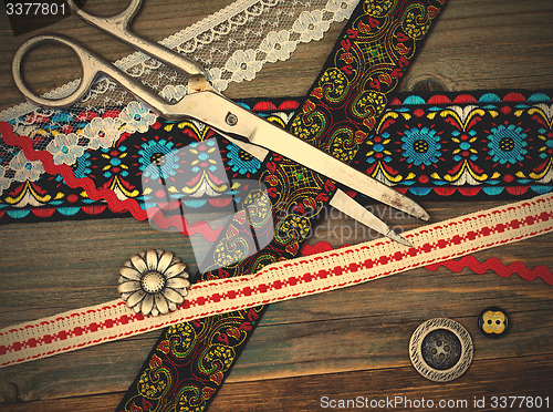 Image of vintage scissors, antique ribbons and classic buttons