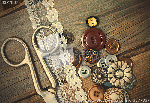 Image of vintage buttons, lace, and a dressmaker scissors