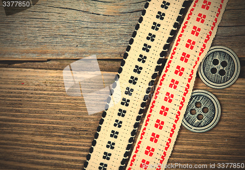 Image of antique ribbons with embroidered ornaments and old buttons