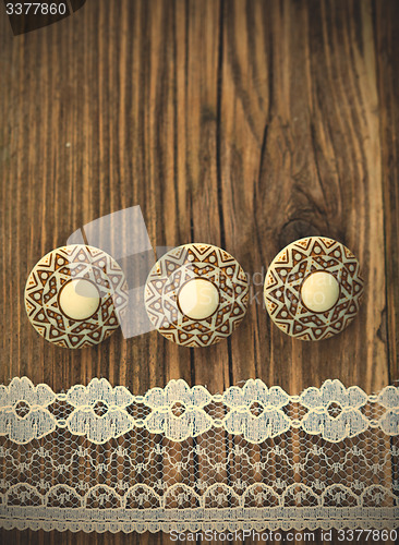 Image of three vintage button and lace tape