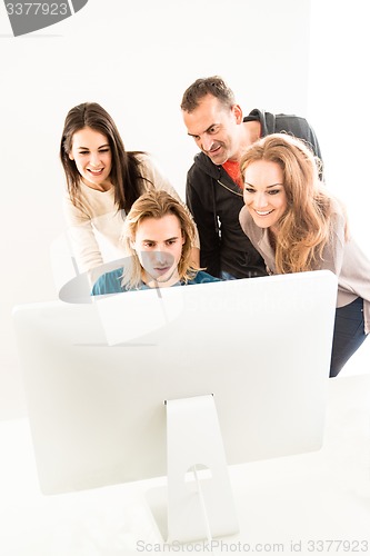 Image of Abstract: Business team in office looking at computer monitor