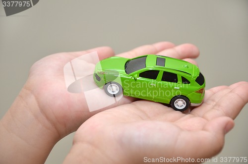 Image of Green toy car on hand 