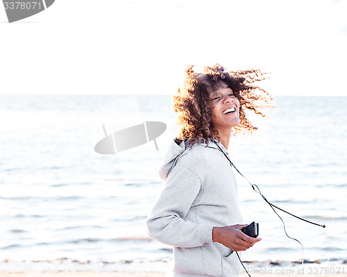 Image of energetic female moving by the ocean