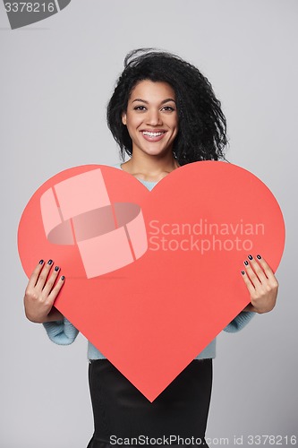 Image of Girl holding big red heart shape