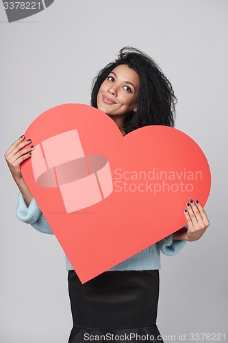 Image of Girl holding big red heart shape