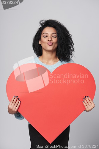 Image of Girl holding big red heart shape