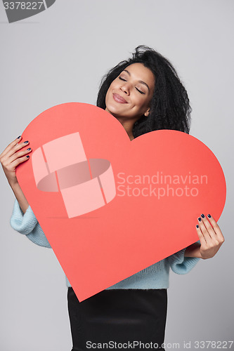 Image of Girl holding big red heart shape