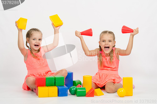 Image of Two girls having fun playing with blocks