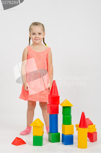 Image of Four-year girl has built a few houses out of blocks