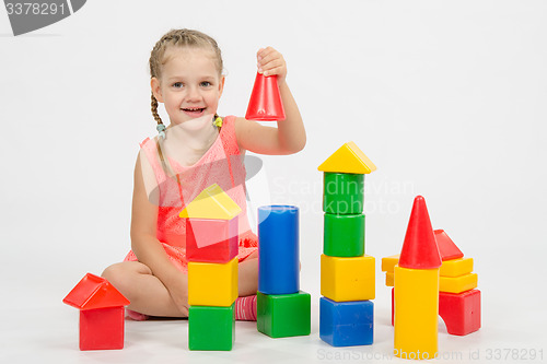 Image of four-year child is having fun playing with blocks