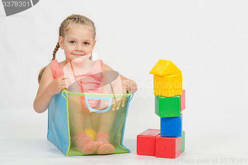 Image of The child climbed indulging in a box for toys