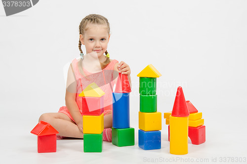 Image of Child cheerfully plays with blocks