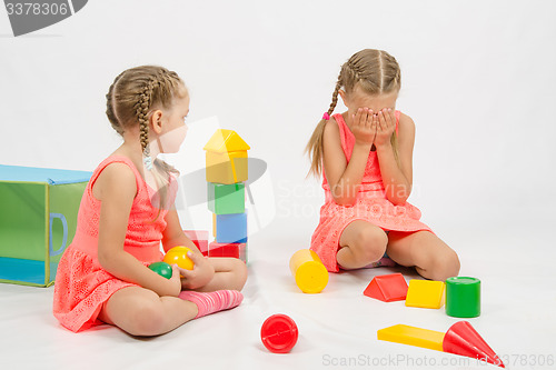 Image of Girl hurt another girl playing with toys