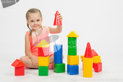 Image of four-year child is having fun playing with blocks